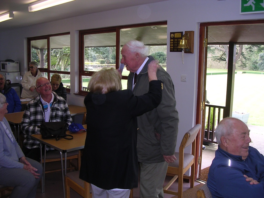 President hugging senior club member