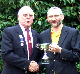 Quentin Smith receives trophy from Captain Rod Payne